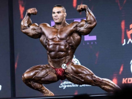 Nick Walker with defined muscles in bodybuilding competition